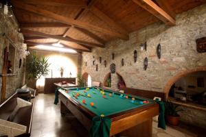 a pool table in a room with a stone wall at Agriturismo Podere Poggiarone in Rapolano Terme