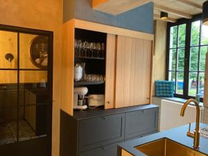 a kitchen with blue cabinets and a counter top at Le Huit in Fumay