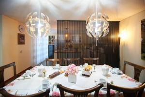 a dining room table with chairs and chandeliers at Casa D'Os Reais in São Cristóvão do Douro