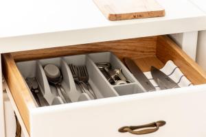 a drawer in a kitchen cabinet filled with utensils at Sobe Poldka in Dolenjske Toplice