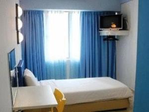 Postel nebo postele na pokoji v ubytování YY38 Hotel
