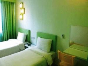 Postel nebo postele na pokoji v ubytování YY38 Hotel + 7 fotografií