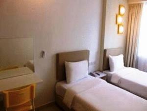 Postel nebo postele na pokoji v ubytování YY38 Hotel
