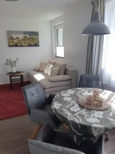 a living room with a table and a couch at Appartement FreiRaum in Sankt Martin am Tennengebirge