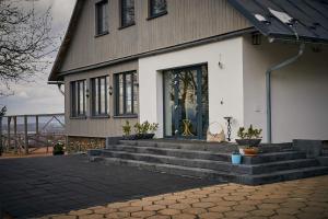a house with steps leading up to a front door at Dom Krawca,Schneiderbaude in Kłodzko