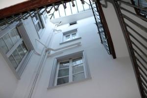 a view of the side of a white building with windows at Beautiful T3 Apt in historical Toulouse city centre in Toulouse +9 photos