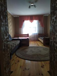 a living room with a couch and a window at Білий птах in Svityazʼ