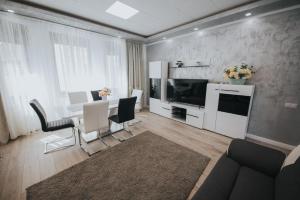 a living room with a dining table and a television at Endlich zuhause in Sibiu