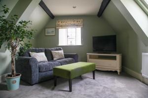 a living room with a couch and a tv at Mortons Manor in Corfe Castle