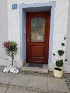 a brown door with a window on a house at Gästeunterkunft Gangkofen in Gangkofen