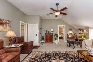 a living room with a couch and a ceiling fan at Jolly's Haus in Fredericksburg