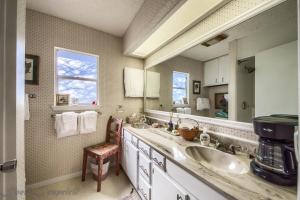 a bathroom with two sinks and a large mirror at Binky's Nest in Fredericksburg