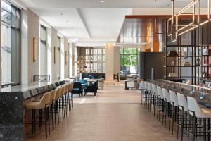 a lobby with chairs and a bar in a building at Four Seasons Hotel Denver in Denver