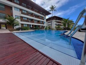 a swimming pool with a slide in front of a building at Cupe Beach Living - Porto de Galinhas in Porto De Galinhas