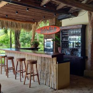 a bar in a restaurant with stools around it at La Veranera, Playa El Coco in San Juan del Sur