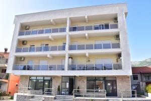 an external view of a building with blue balconies at Apartmani Bokica in Trebinje