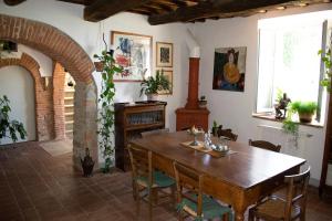 a dining room with a wooden table and chairs at Villa Gioietta in Strada