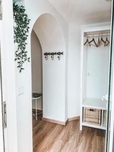 a room with white walls and a door with a plant at VillaMar Figueira da Foz in Figueira da Foz