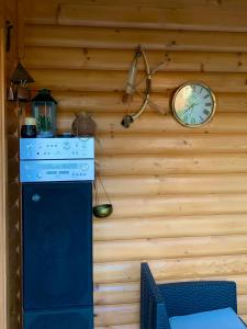 a clock on the wall of a kitchen with a stove at Apartment Sunny Place in Bihać