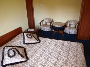 um quarto com três cadeiras e uma cama em Hotel Okatex em Zagań