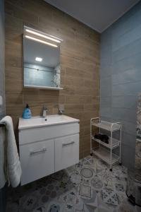 a bathroom with a white sink and a mirror at Villa Angels Golf in Balchik
