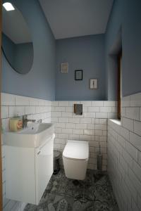 a bathroom with a white toilet and a sink at Villa Angels Golf in Balchik +19 photos