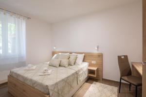 Ένα ή περισσότερα κρεβάτια σε δωμάτιο στο Direct Beach Apartments