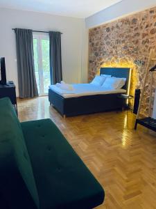 a bedroom with a large bed and a wooden floor at Omega54 City Suites Athens Central Business District in Athens