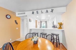 a dining room with a wooden table and chairs at Red Roof Retreat in Rancho Mirage