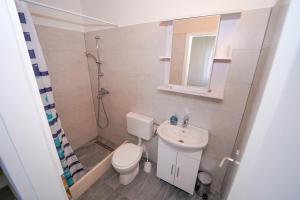 a small bathroom with a toilet and a sink at House Relax in Selca +19 photos