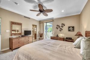 a bedroom with a bed and a ceiling fan at Kapalua Golf Villas 16V3 in Kahana