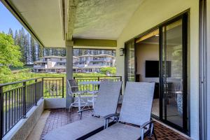 a porch with three chairs and a table on a balcony at Kapalua Golf Villas 16V3 in Kahana