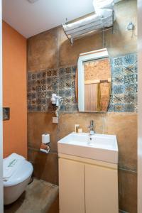 a bathroom with a sink and a toilet and a mirror at Cedrus Hotel in Antalya +59 photos
