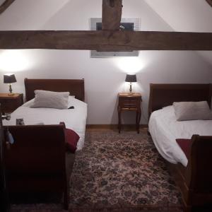 Ein Bett oder Betten in einem Zimmer der Unterkunft Chambres à la Perquette