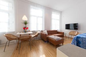 a living room with a couch and a table at Apartments Leonardo in Bolzano