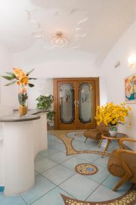 a room with a counter and chairs and a table at Hotel & Residence Matarese in Ischia