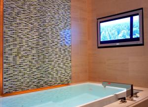 a bath tub with a tv in a bathroom at SKYLOFTS at MGM Grand in Las Vegas