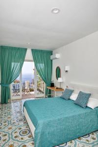 a hotel room with a bed and a balcony at Malafemmena Guest House in Capri