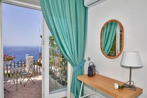 a room with a window with a view of the ocean at Malafemmena Guest House in Capri