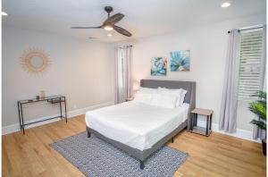 a bedroom with a bed and a ceiling fan at Brand New Remodeled 3BR2BA House Near Downtown in San Antonio