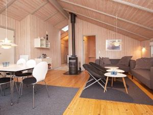 a living room with a couch and a table at 8 person holiday home in Melby in Melby