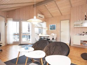 a living room with two tables and chairs at 8 person holiday home in Melby in Melby