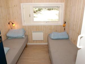 two beds in a small room with a window at 8 person holiday home in Nex in Vester Sømarken