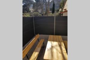 a wooden bench sitting on top of a fence at Calanques de Sormiou in Marseille