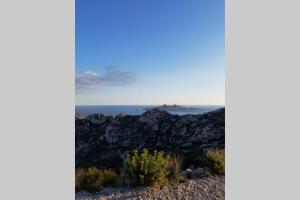 a view of the ocean from the top of a mountain at Calanques de Sormiou in Marseille