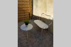 a white chair and a table with a plant at Calanques de Sormiou in Marseille