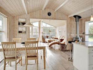 a kitchen and living room with a table and chairs at 6 person holiday home in Hj rring in Hjørring