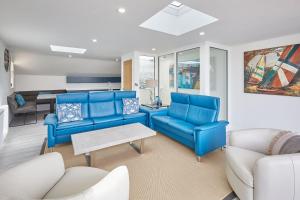 a living room with blue chairs and a table at Host & Stay - The Townhouse in Whitby