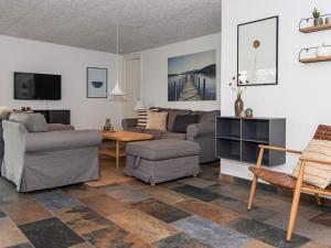 a living room with a couch and a table at Holiday home Ebeltoft XXI in Ebeltoft