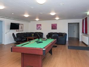 a living room with a pool table and couches at Modern Holiday Home in Jutland with Terrace in Hurup